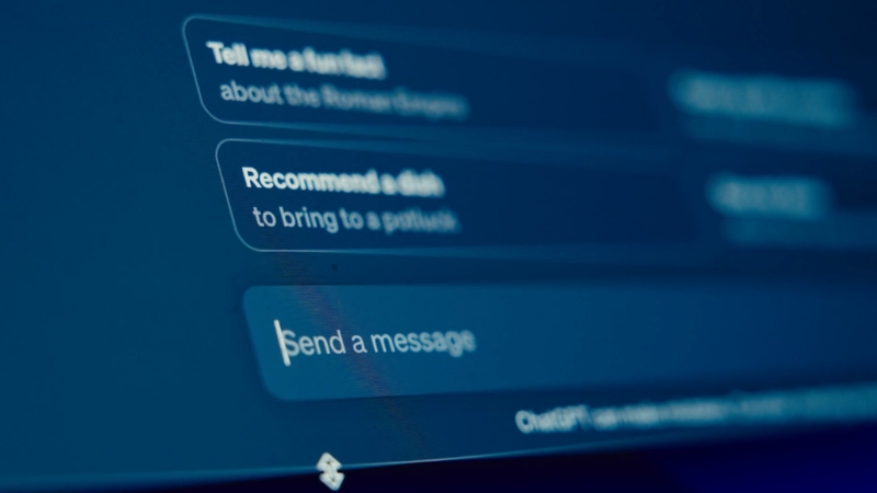 A close-up of an AI chat screen with typed prompts and reply options