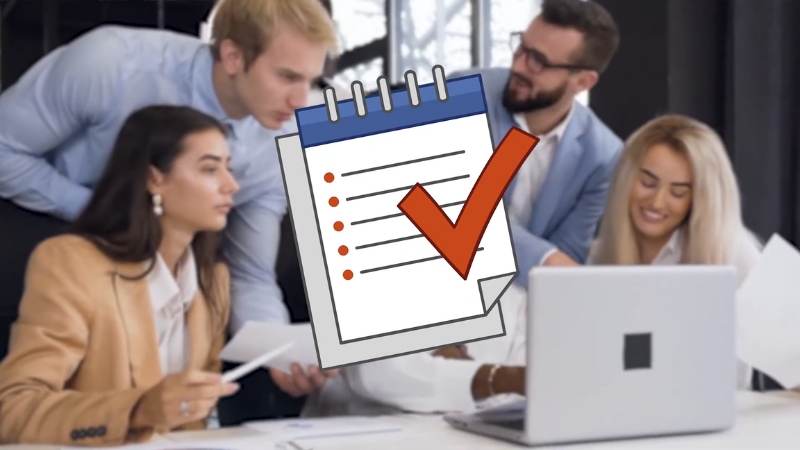 Team reviewing documents beside a laptop with a checklist icon, representing an ad approval checklist