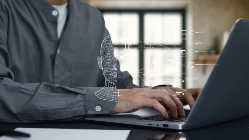 Blogger works on a laptop as AI data overlays show content and SEO structure