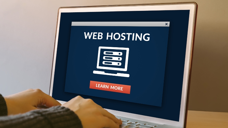 Laptop screen displaying a web hosting service interface with a learn more button